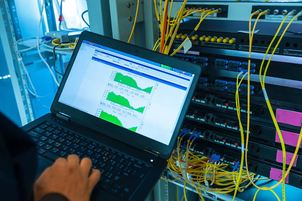 phx-IT technician, fixing network switch and server in data center room .